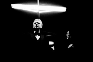 Andrea Bocelli standing under the lamp with his tour manager Massimo Nebuloni in the background.