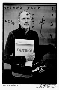 Anton Corbijn holding an envelope in his hand with names of his books.