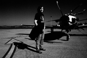 Emir Kusturica in front of his private jet wearing t-shirt with Gagarin portrait at the airport.