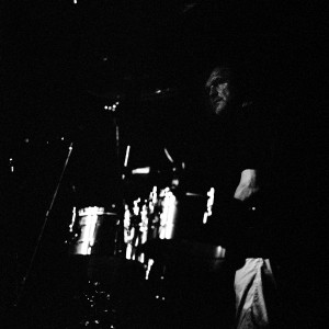 Emir Kusturica playing drums on the stage at a concert of No Smoking Orchestra.