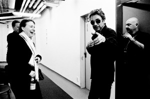 Jean-Michel Jarre pointing his finger to the camera in the backstage before his concert with his manager Fiona Commins and his tour manager Chris Rowley.