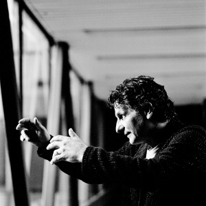 John Patitucci posing and making a gesture with his hands.