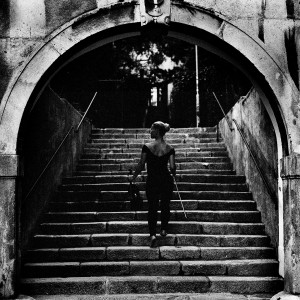 Mari Samuelsen walks the stairs holding violin and fiddlestick.