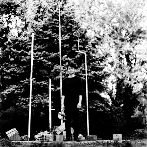 Masayoshi Fujita standing at the tubes in a park with trees.
