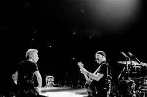 U2 members The Edge, Bono Vox and Adam Clayton on the stage at the concert playing.